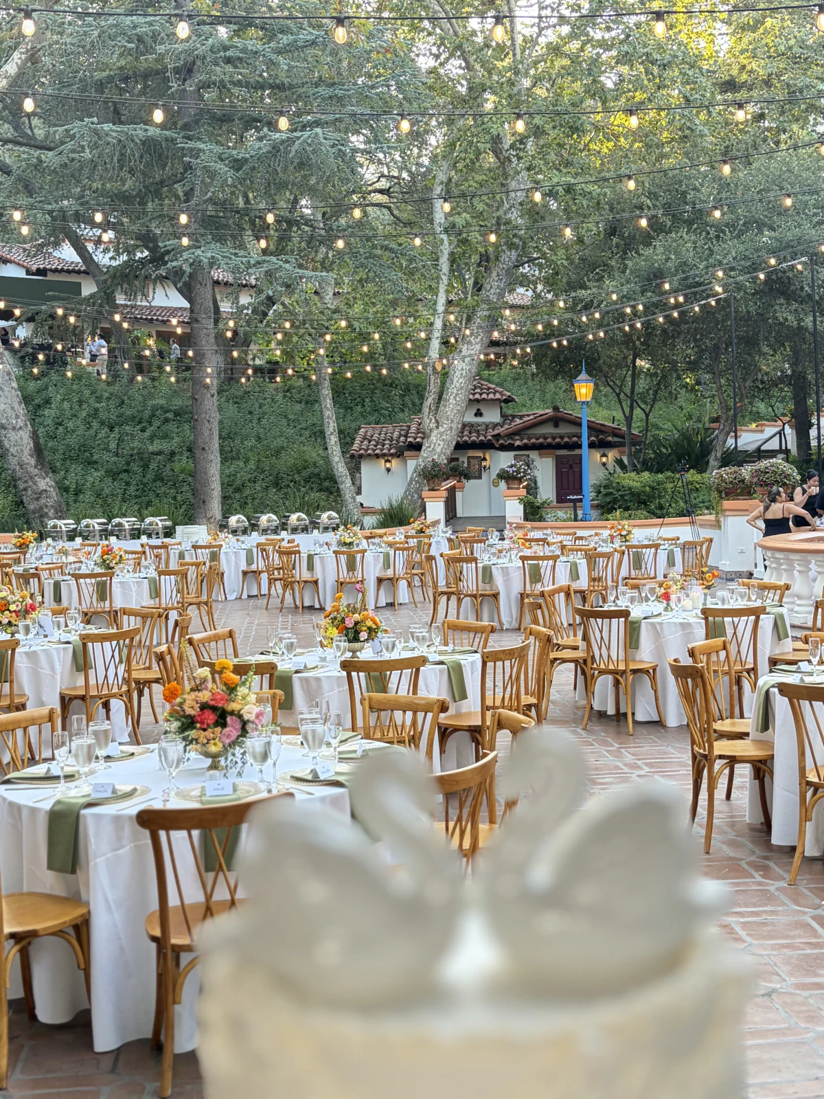 Garden wedding reception beneath string lights